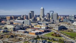 The city's skyline in Downtown Indianapolis, Indiana seen from smaller brick buildings Aerial Stock Photos | DXP001_090_0005