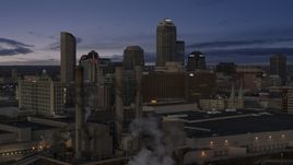 Smoke stacks and a view of city skyline at twilight in Downtown Indianapolis, Indiana Aerial Stock Photos | DXP001_093_001