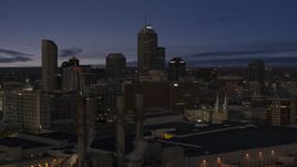 Giant skyscrapers of the city skyline at twilight, seen from smoke stacks, Downtown Indianapolis, Indiana Aerial Stock Photos | DXP001_093_005