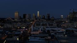 A wide view of skyscrapers reflecting light in the city skyline at twilight in Downtown Nashville, Tennessee Aerial Stock Photos | DXP002_115_0009