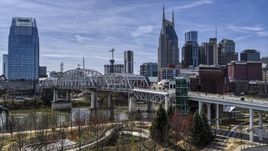 A pedestrian bridge with view of Broadway across the Cumberland River, Downtown Nashville, Tennessee Aerial Stock Photos | DXP002_117_0008
