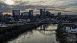 The city skyline behind a bridge on Cumberland River at sunset, Downtown Nashville, Tennessee Aerial Stock Photos | DXP002_119_0009