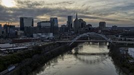 The city skyline behind a bridge on Cumberland River at sunset, Downtown Nashville, Tennessee Aerial Stock Photos | DXP002_119_0010