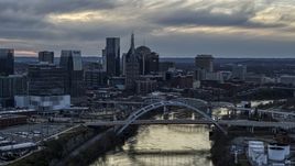A view of the riverfront skyline and bridges spanning the Cumberland River at sunset, Downtown Nashville, Tennessee Aerial Stock Photos | DXP002_120_0008
