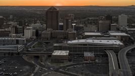 Office tower and shorter hotel tower behind convention center at sunset, Downtown Albuquerque, New Mexico Aerial Stock Photos | DXP002_122_0011