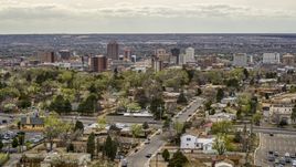 Wide view of city's high-rises seen while flying by homes, Downtown Albuquerque, New Mexico Aerial Stock Photos | DXP002_126_0005