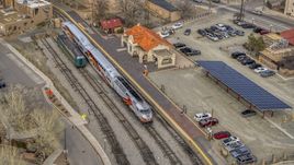 A view of a passenger train at the station in Santa Fe, New Mexico, tilt to top of the train Aerial Stock Photos | DXP002_130_0008