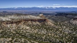 A wide view of desert mesas and distant mountains in New Mexico Aerial Stock Photos | DXP002_133_0005