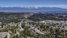 A wide view of distant mountains seen from homes near mesas and canyons in Los Alamos, New Mexico Aerial Stock Photos | DXP002_134_0004