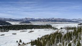 Distant mountains seen across a snowy valley, New Mexico Aerial Stock Photos | DXP002_134_0007