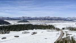 A view of distant mountains on the other side of a snowy valley, New Mexico Aerial Stock Photos | DXP002_134_0008