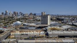 A grain elevator, with the skyline of  Downtown Phoenix, Arizona in the background Aerial Stock Photos | DXP002_136_0009