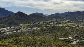 A view of homes and golf course near a mountain peak in Tucson, Arizona Aerial Stock Photos | DXP002_145_0001
