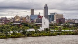 A fountain and riverfront park with view of skyline, Downtown Omaha, Nebraska Aerial Stock Photos | DXP002_169_0006