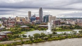 The city's skyline while seen from near a park fountain, Downtown Omaha, Nebraska Aerial Stock Photos | DXP002_169_0009