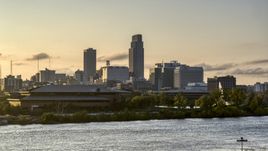 The skyline at sunset, seen from the river, Downtown Omaha, Nebraska Aerial Stock Photos | DXP002_172_0006
