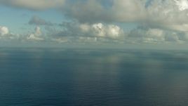 HD aerial stock footage fly over the Gulf of Mexico and beneath clouds, and pan across the water Aerial Stock Footage | AF0001_000186