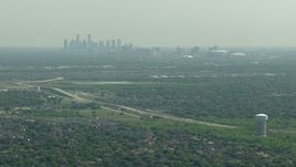 HD aerial stock footage approach Fort Bend Parkway with a view of the skyline of Downtown Houston, Texas Aerial Stock Footage | AF0001_000247