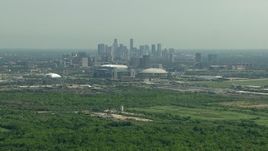 HD aerial stock footage approach NRG Stadium and Houston Astrodome near the Downtown Houston, Texas skyline Aerial Stock Footage | AF0001_000253