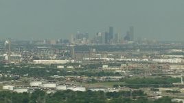 HD aerial stock footage of the city skyline seen from oil refineries in Pasadena, Downtown Houston, Texas Aerial Stock Footage | AF0001_000296