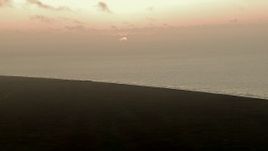 HD aerial stock footage of the rising sun visible from marshland by Gulf of Mexico, sunrise Aerial Stock Footage | AF0001_000336