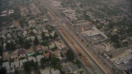HD aerial stock footage of a reverse view of homes by San Fernando Road in Sylmar, California Aerial Stock Footage | AF0001_000352