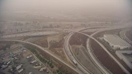 HD aerial stock footage of the Interstate 5 / 210 Freeway interchange on a fog day, Sylmar, California Aerial Stock Footage | AF0001_000356