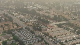 HD aerial stock footage of a view of Foothill Road, apartment buildings, and the 210 Freeway, on a foggy day, Sylmar, California Aerial Stock Footage | AF0001_000357