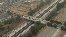 HD aerial stock footage of light traffic on the 210 Freeway, and the Sayre Street and Hubbard Street overpasses, Sylmar, California Aerial Stock Footage | AF0001_000360