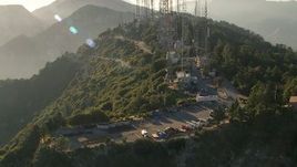 HD aerial stock footage flyby service vehicles and parts for the radio towers on Mount Wilson, San Gabriel Mountains, California, sunset Aerial Stock Footage | AF0001_000492