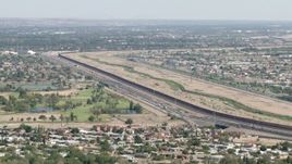 HD aerial stock footage of the US/Mexico border fence by 375 freeway and golf course, El Paso, Texas Aerial Stock Footage | AF0001_000942