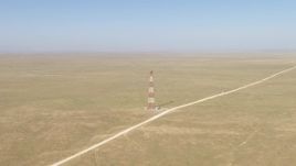 HD aerial stock footage approach a tower by a dirt road in a desert plain near El Paso, Texas Aerial Stock Footage | AF0001_000960