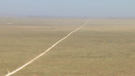 HD aerial stock footage of a dirt road through a wide desert plain near El Paso, Texas Aerial Stock Footage | AF0001_000961