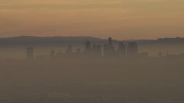 5K aerial stock footage of the Downtown Los Angeles skyline in haze at sunset, California Aerial Stock Footage | AF0001_000978