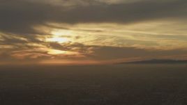 5K aerial stock footage of sunset behind clouds over Los Angeles, California Aerial Stock Footage | AF0001_000981