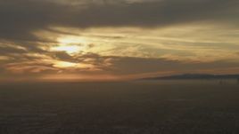 5K aerial stock footage of a view across Los Angeles at the sunset behind clouds, California Aerial Stock Footage | AF0001_000982