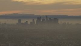 5K aerial stock footage of a view of the Downtown Los Angeles skyline in haze at sunset, California Aerial Stock Footage | AF0001_000985
