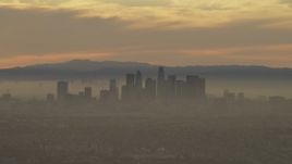 5K aerial stock footage of passing the Downtown Los Angeles skyline in haze at sunset, California Aerial Stock Footage | AF0001_000986