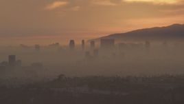 5K aerial stock footage of Century City skyscrapers in haze at sunset, California Aerial Stock Footage | AF0001_000993