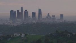 5K aerial stock footage of Downtown Los Angeles skyline seen while flying behind Dodger Stadium at twilight, California Aerial Stock Footage | AF0001_000998