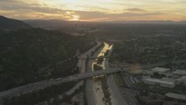 5K aerial stock footage of heavy traffic on 134 and I-5 by the Los Angeles River and neighborhoods at sunset, Burbank, California Aerial Stock Footage | AF0001_001007