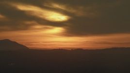 5K aerial stock footage of clouds lit by the setting sun over Los Angeles mountains, California Aerial Stock Footage | AF0001_001009
