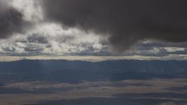 8K aerial stock footage of dark clouds over desert and mountain ridges in Southern California Aerial Stock Footage | AF0001_001017