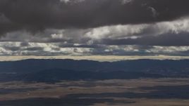 8K aerial stock footage of thick clouds over desert and mountain ridges in Southern California Aerial Stock Footage | AF0001_001018