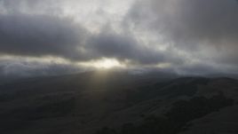 8K aerial stock footage of thick clouds over rolling hills at sunset in Southern California Aerial Stock Footage | AF0001_001027