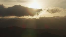 8K aerial stock footage of setting sun behind clouds and mountain ridges in Southern California Aerial Stock Footage | AF0001_001031