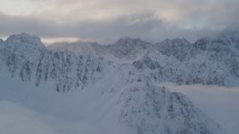 4K aerial stock footage snow covered Chugach Mountains, clouds, Chugach National Forest, Alaska Aerial Stock Footage | AK0001_0013