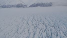 4K aerial stock footage fly over Knik Glacier,  Chugach Mountains, low clouds, Knik Glacier, Alaska Aerial Stock Footage | AK0001_0027