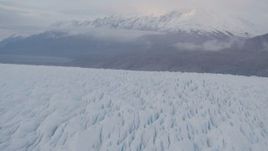 4K aerial stock footage flying low over Knik Glacier, tilt down to close up of the surface, Knik Glacier, Alaska Aerial Stock Footage | AK0001_0028