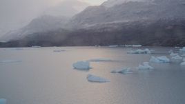 4K aerial stock footage shoreline, reveal icebergs, snow covered mountains, Inner Lake George, Alaska Aerial Stock Footage | AK0001_0044